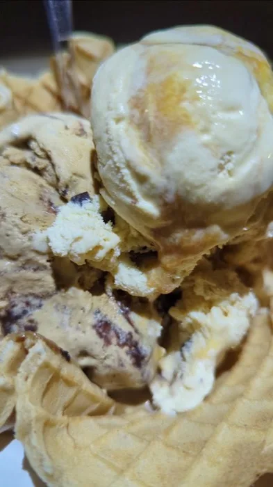 Caramel swirl ice cream in a waffle cone at Polar Cave